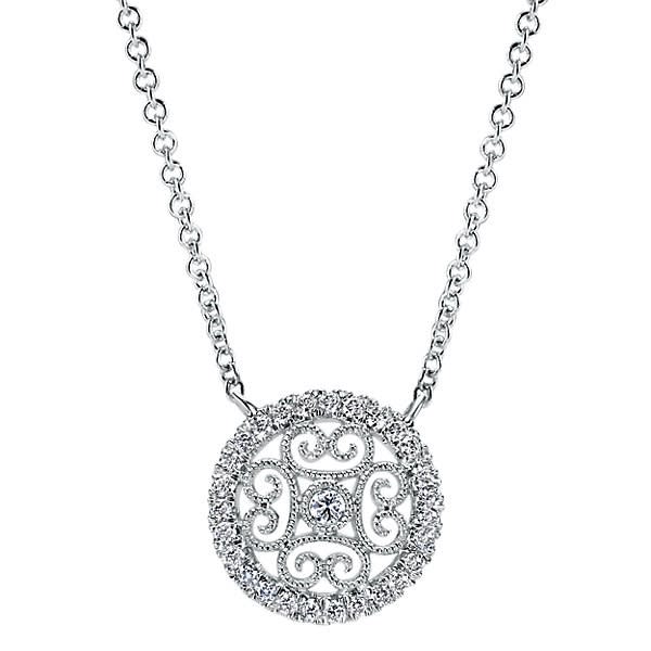 White gold stylings meet a center diamond with a round diamond halo in this artful 14k white gold diamond necklace. White gold stylings meet a center diamond with a round diamond halo in this artful 14k white gold diamond necklace.