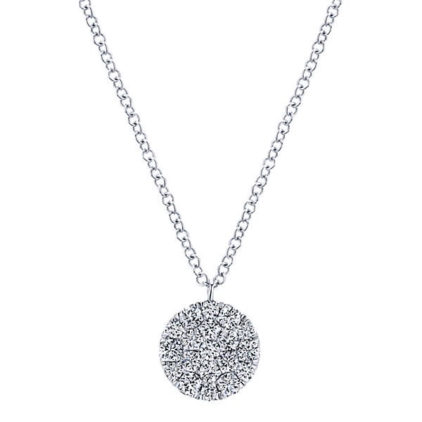 A beautiful diamond disc necklace hangs gracefully from a sturdy ink chain in this dynamic 14k white gold diamond necklace.