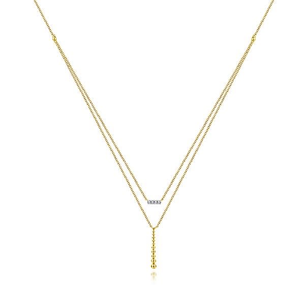 Two layered necklaces in one 14k yellow diamond bar necklace.