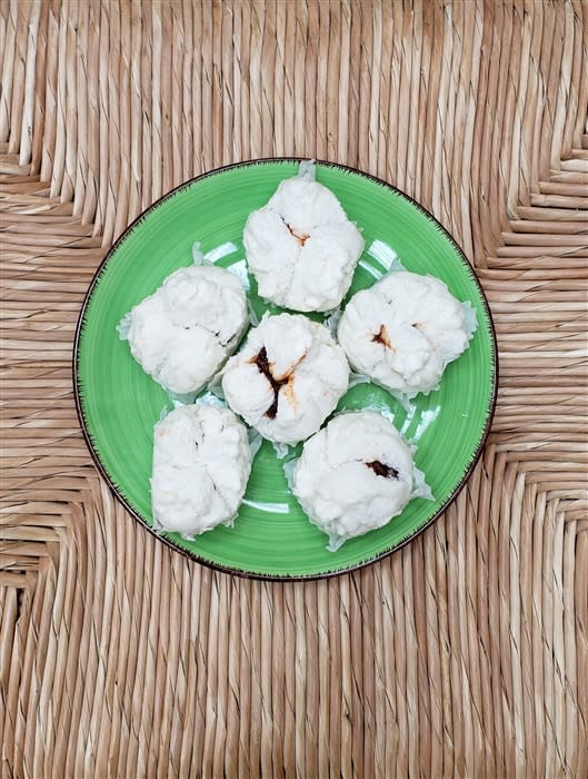 Buddha Bodai Vegan BBQ Meat Buns, featuring world-famous fluffy buns filled with homemade BBQ meat, beautifully arranged on a plate, showcasing a delicious plant-based treat that is both satisfying and flavorful.