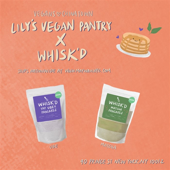 Whisk'd Vegan Black Sesame Pancake Mix package displayed on a countertop, featuring a serving suggestion of fluffy black sesame pancakes topped with syrup and fresh fruit.