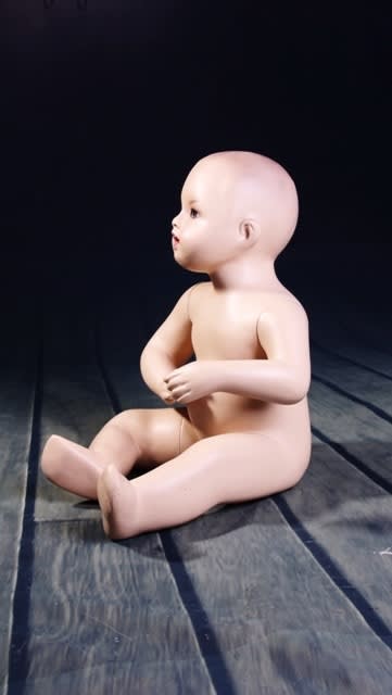Realistic fleshtone sitting toddler mannequin made of fiberglass for retail clothing display. Realistic fleshtone sitting toddler mannequin made of fiberglass for retail clothing display.