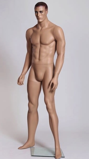 Realistic athletic male mannequin with molded hair made of fleshtone fiberglass on a clear glass base for retail window displays.