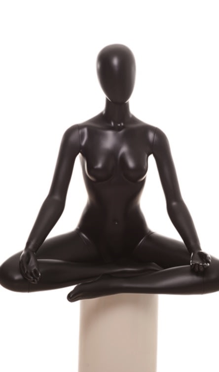 Female yoga mannequin in OM meditation pose made of matte black fiberglass with an abstract egghead.