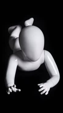 Glossy white toddler mannequin with abstract egghead in a belly-down laying pose for retail display.