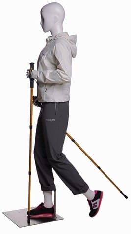Female hiking mannequin in glossy white holding walking stick for outdoor apparel and retail display