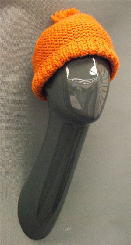 Metallic gray fiberglass abstract female display head with long neck and wall-mounted base for retail merchandising.