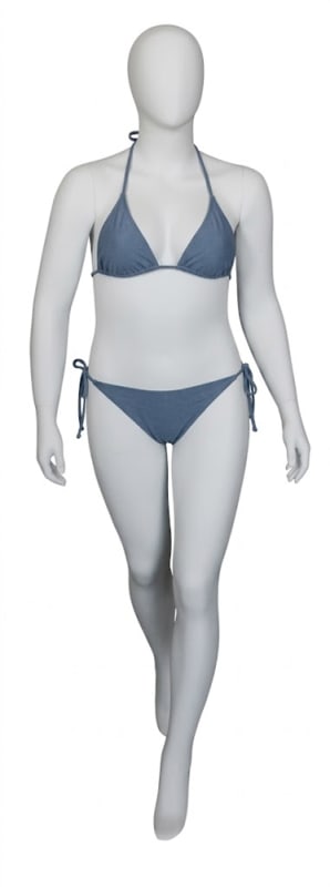 Matte white plus-size female mannequin in walking pose with fiberglass body and glass base for retail display