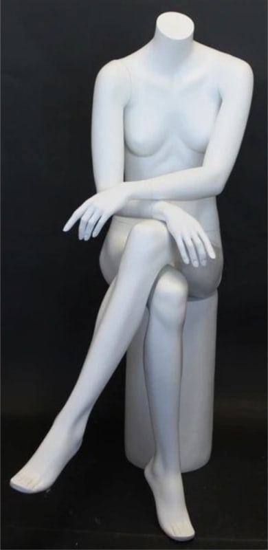 Matte white female headless fiberglass mannequin sitting in a cross-leg pose with hands on lap for boutique and retail clothing displays.