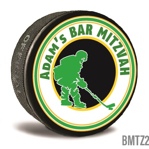 A custom printed hockey puck is personalized in bright colors and text written to personalize it for the recipients. Celebrate your Bar Mitzvah and  let guests take home a memory.