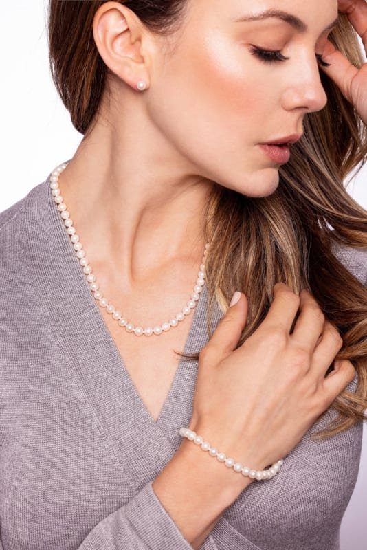 Three piece 6-6.5mm Freshwater Pearl Set. Includes 18" Strand, 7.5" Bracelet and Studs. All in sterling silver, presented in a wood gift box.