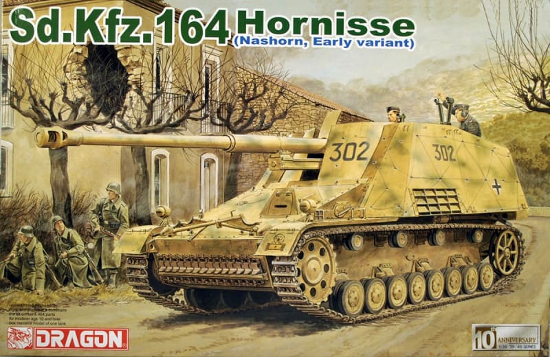Box art illustration of Sd.Kfz 164 Hornisse rolling through the street of a small village.