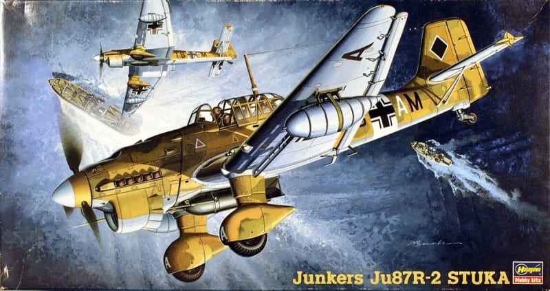 Box art illustration of Junkers Ju 87R-2 plastic model kit by Hasegawa of the WWII long-range dive bomber, Ju 87R-2 Stuka in a steep dive at night with another Stuka flying above it.