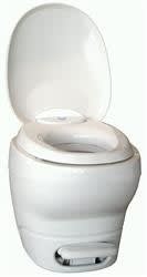 The Thetford 31084 is an Aqua-Magic Bravura RV toilet in a high-profile, white design. It features a comfortable 16-1/4 inch seat height, a single-pedal pulsating flush system, and is designed for easy installation with a universal floor flange.