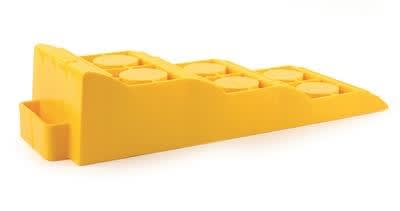 The Camco Tri-Leveler 44573 is a yellow, plastic ramp is designed to help level an RV or camper on uneven ground to ensure appliances and tanks operate efficiently.