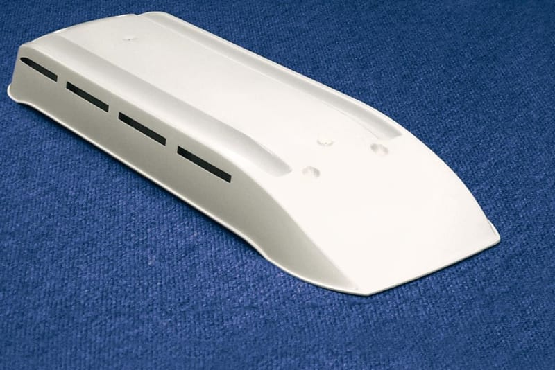 The Norcold Refrigerator Vent White, model 622293CBW, is a low-profile plastic roof vent cap designed for RV refrigerators.
