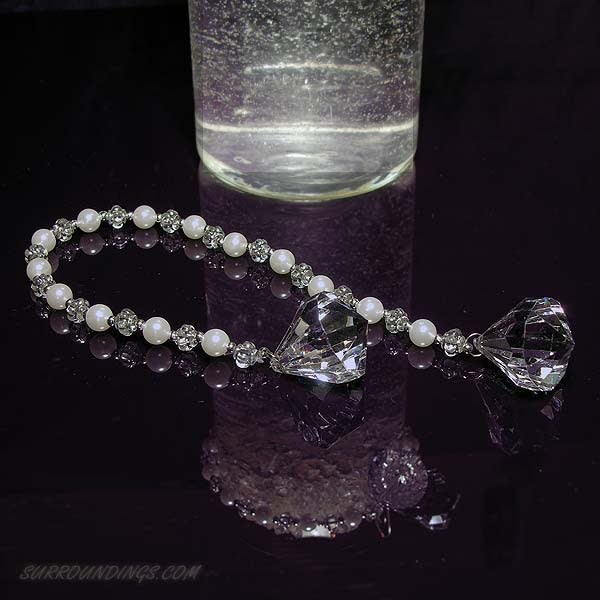 Diamond pearl tassel around 4" vase, being held with silver swirl hook