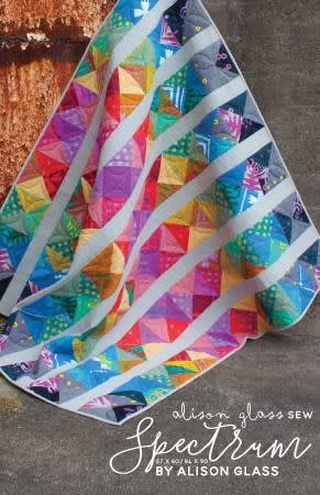Spectrum Modern Quilt Pattern by Alison Glass shows a bright and colorful strippy quilt that features bright and vivid colors in a modern quilt design.