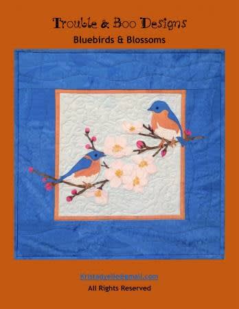 BLUEBIRDS & BLOSSOMS Quilt Pattern by Trouble & Boo shows a pair of bluebirds esting ona branch with spring dogwood blossoms.