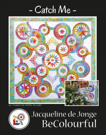 Catch Me Quilt Pattern by BeColourfulshows a picture of a multicolor quilt with rings of stars in various sizes.