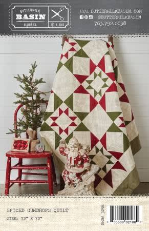 Spiced Gumdrop Quilt Pattern by Buttermilk Basin shows a red and green star quilt on a cream background, with large, easy to  piece quilt blocks.