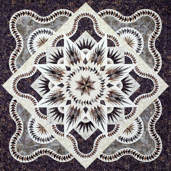 ARTIC STAR QUEEN Quilt Pattern by Judy Niemeyer shows a black and white center medallion quilt in dark batiks with intricate foundation piecing and an undulating border.