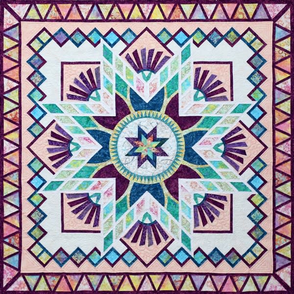 TULIP FARM Quilt Pattern by Judy Niemeyer shows a  blue and white center medallion quilt in bright batiks with intricate foundation piecing and an star  border.
