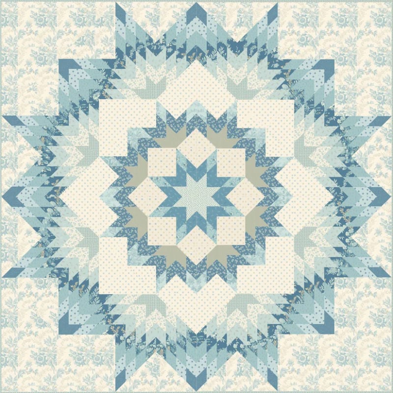 Dallas Quilt Pattern in Sewing Bird by Laundry Basket Quilts by Laundry Basket Quilt shows a star quilt in cream and shades of blue.