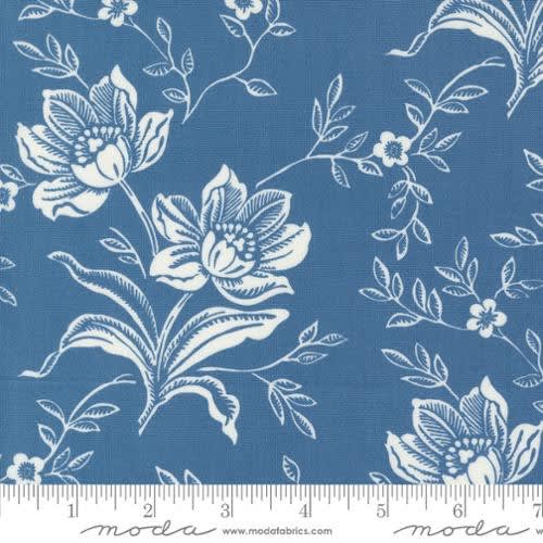 Denim & Daisies Woodcut Bloom Large Floral Denim shows a white outlined flower on a Denim blue colored ground.
