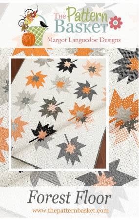 This quilt depicts graphic fall leaves as a quilt block, in a modern interpretation of grays and pumpkin , from The Pattern Basket