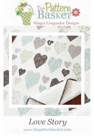 This quilt has soft blue and gray hearts and is  by The Pattern Basket