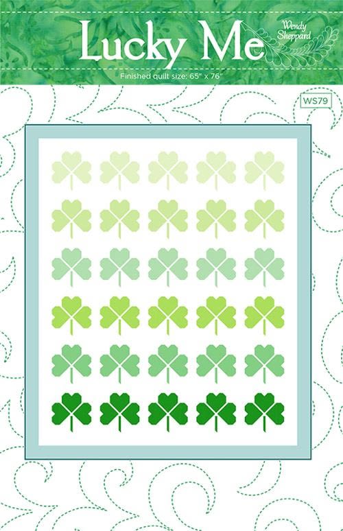 The cover shows a quilt with shamrocks in a pretty green and white quilt.