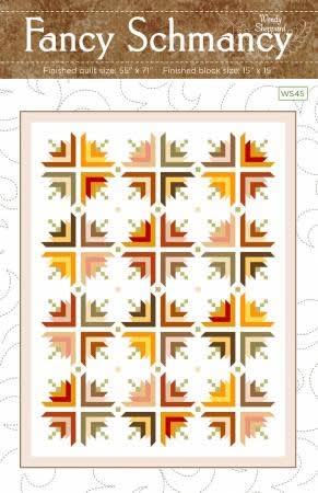 The cover shows a quilt with sphere like shapes that are created thru color placement in simple pieced blocks, with a very modern vibe.