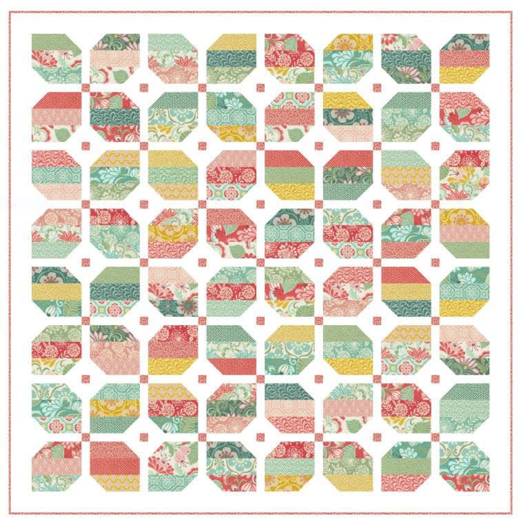 The cover shows a quilt in a variety of colors with a pieced border.