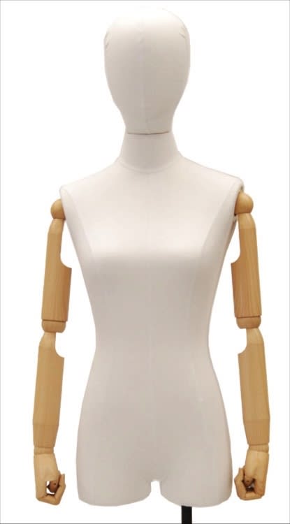 Fully posable egghead female dress form upholstered in white linen with adjustable beechwood-color arms and a brushed steel metal base.