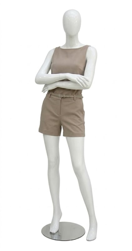 Glossy white fiberglass female mannequin with arms crossed pose and metal base for modern retail clothing display