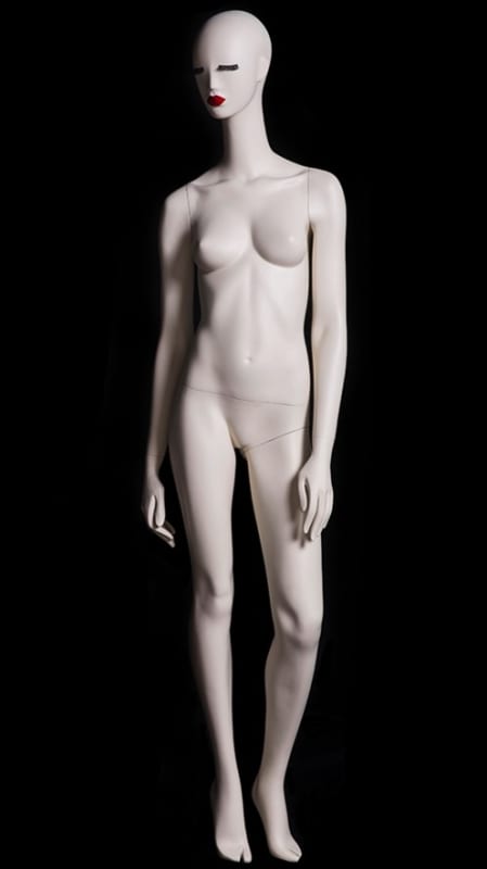 Abstract female mannequin in silky matte cream fiberglass with red lips, black eyelashes, and a round glass base.