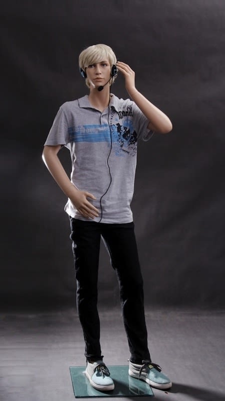 Realistic male teenage mannequin with bent arms and natural skin tone standing on a square glass base.