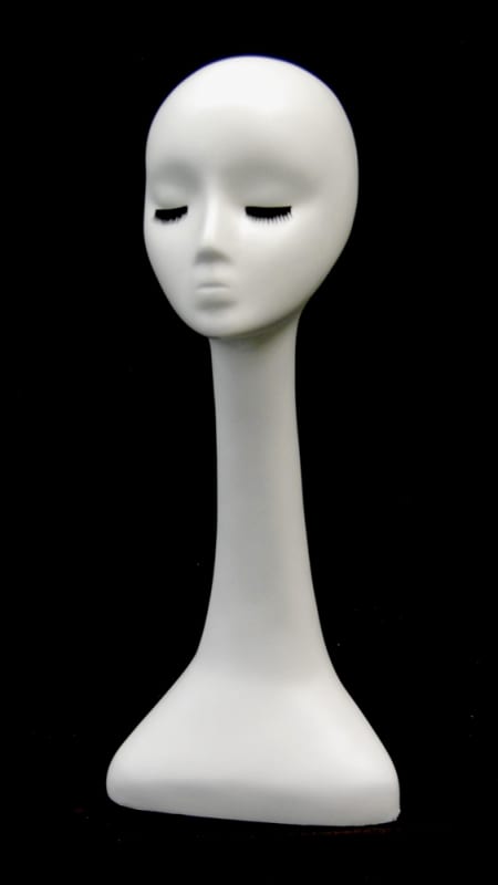 Female fiberglass display head with long neck and eyelashes for retail accessory merchandising.