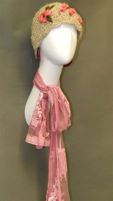 Glossy white fiberglass abstract female display head with long neck and wall-mounted base for retail accessory display.