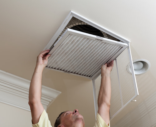 man replacing air filter