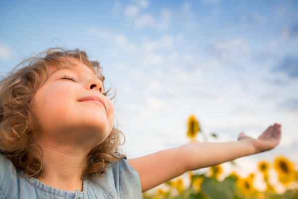 child breathing fresh air