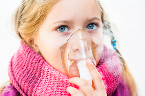 girl with asthma inhaler