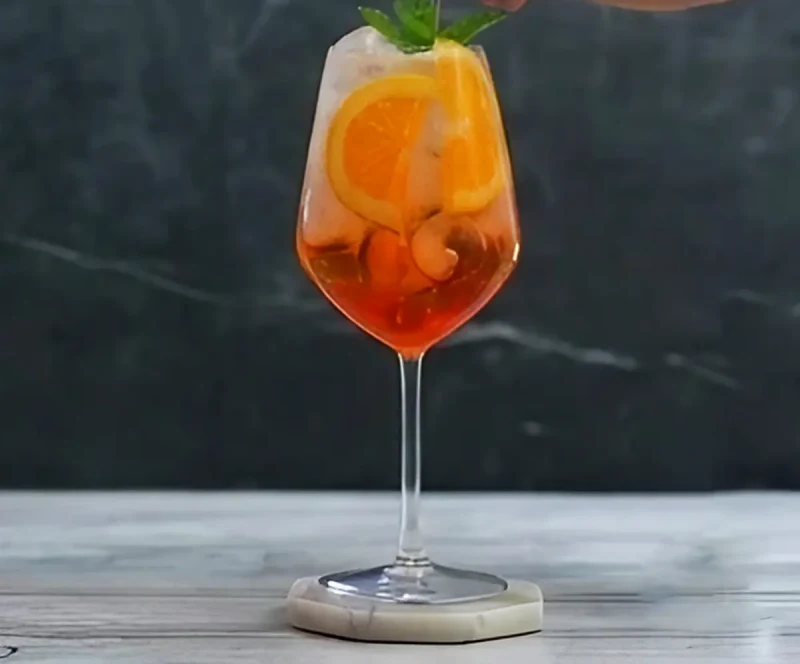 Garnish with orange and serve at once