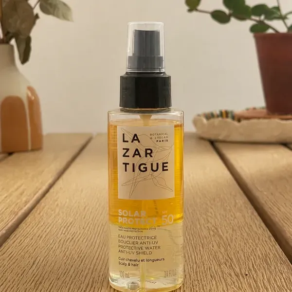 Le flacon de Solar Protect SPF 50+ de Lazartigue posé sur une table pendant mon test
