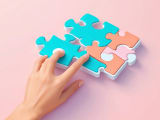 Human hand dragging digital puzzle pieces that morph into an efficient, automated workflow machine