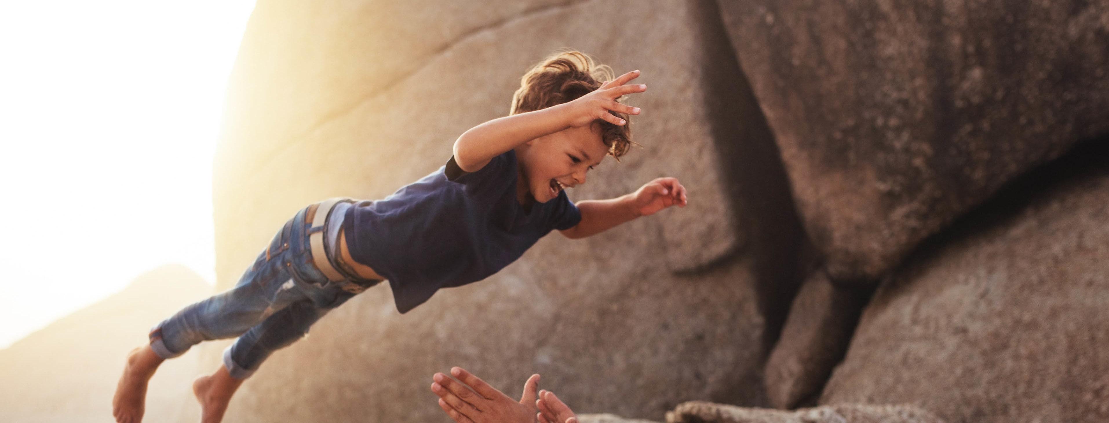 Boy leaping into father's arms