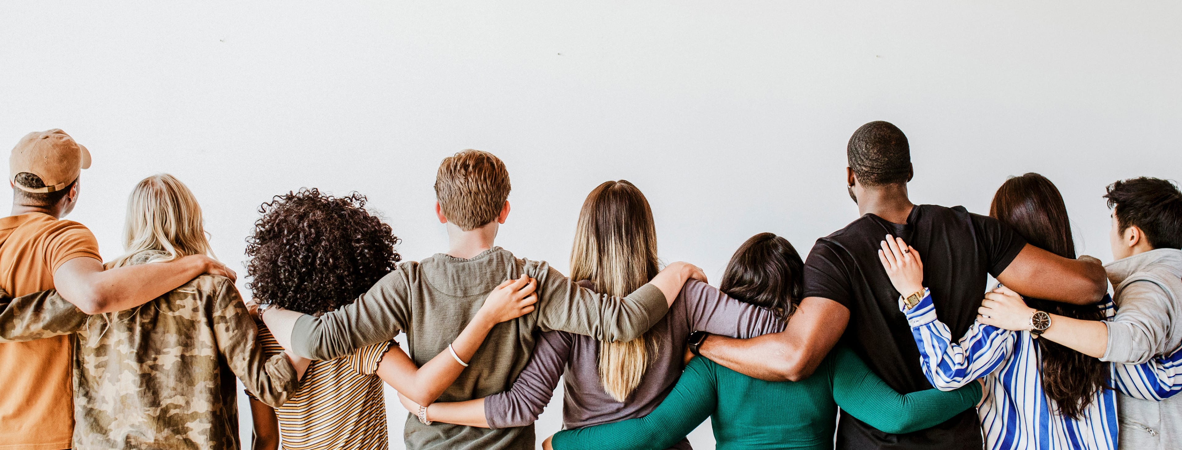 Rearview of diverse people hugging each other