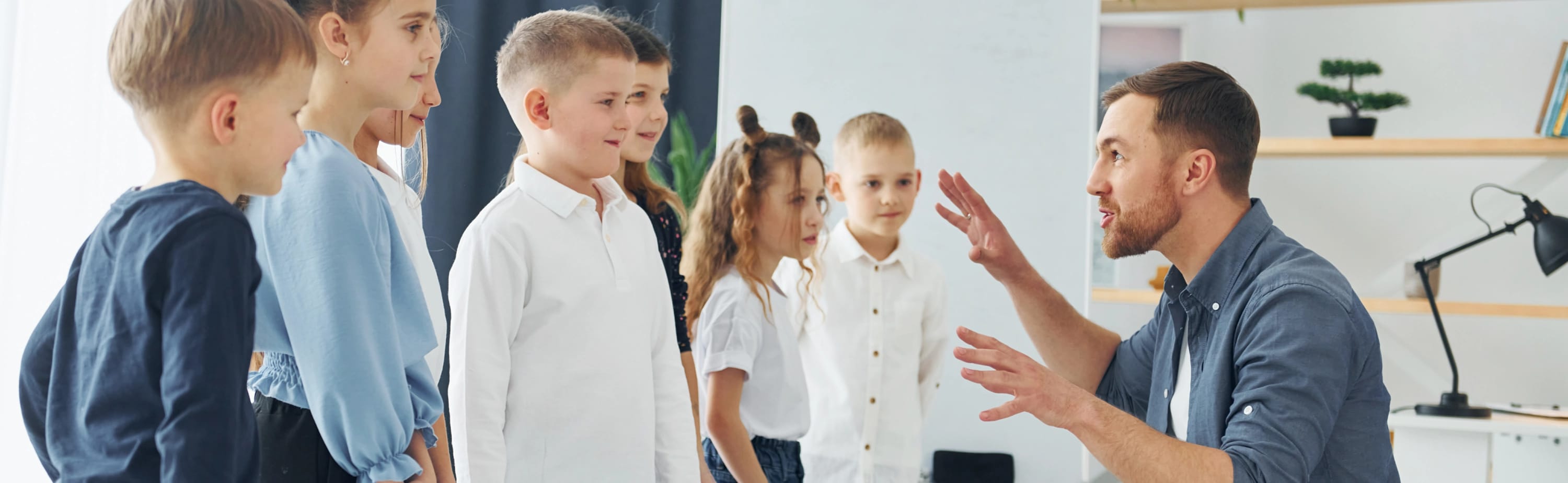 Man telling a story to a group of children