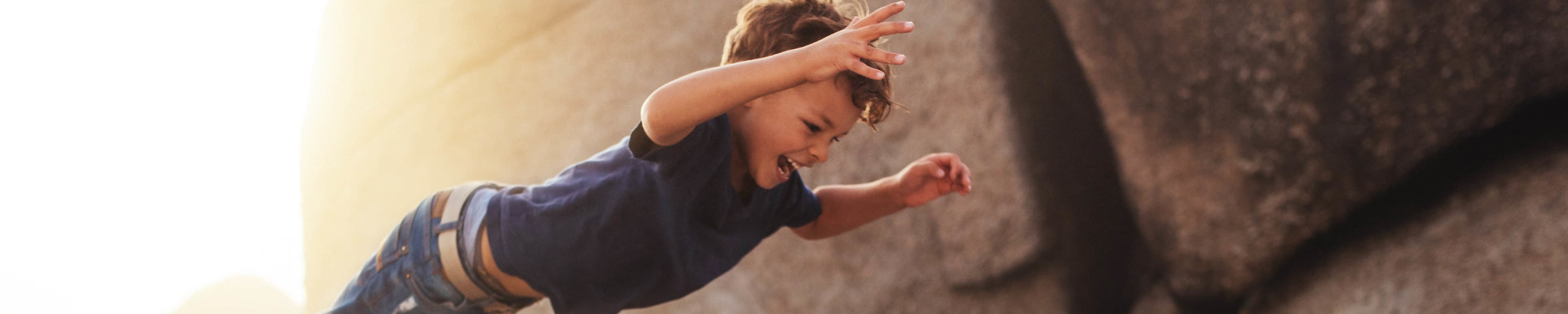Boy leaping into father's arms